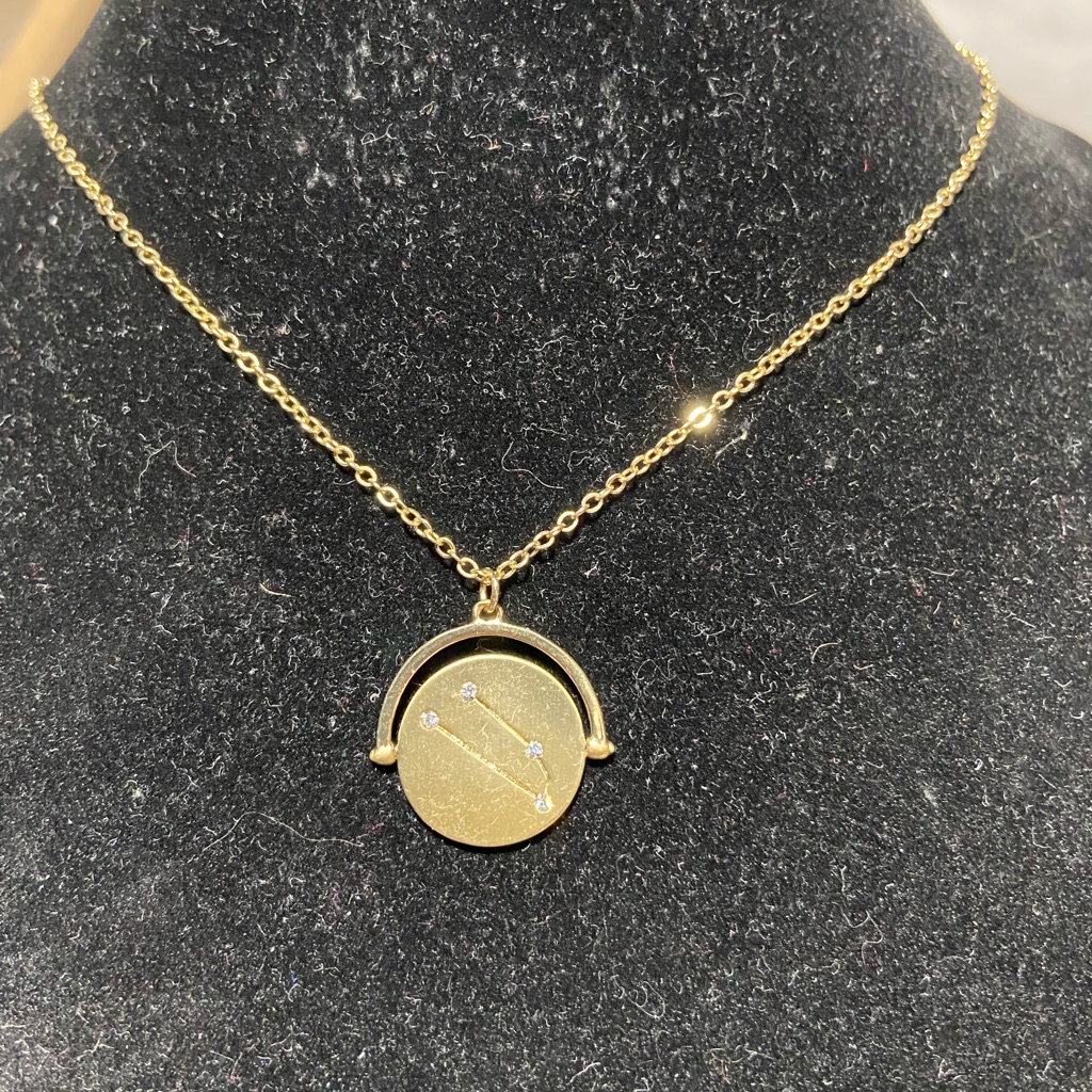 Gold Tone Taurus Zodiac Flip Pendant Necklace.